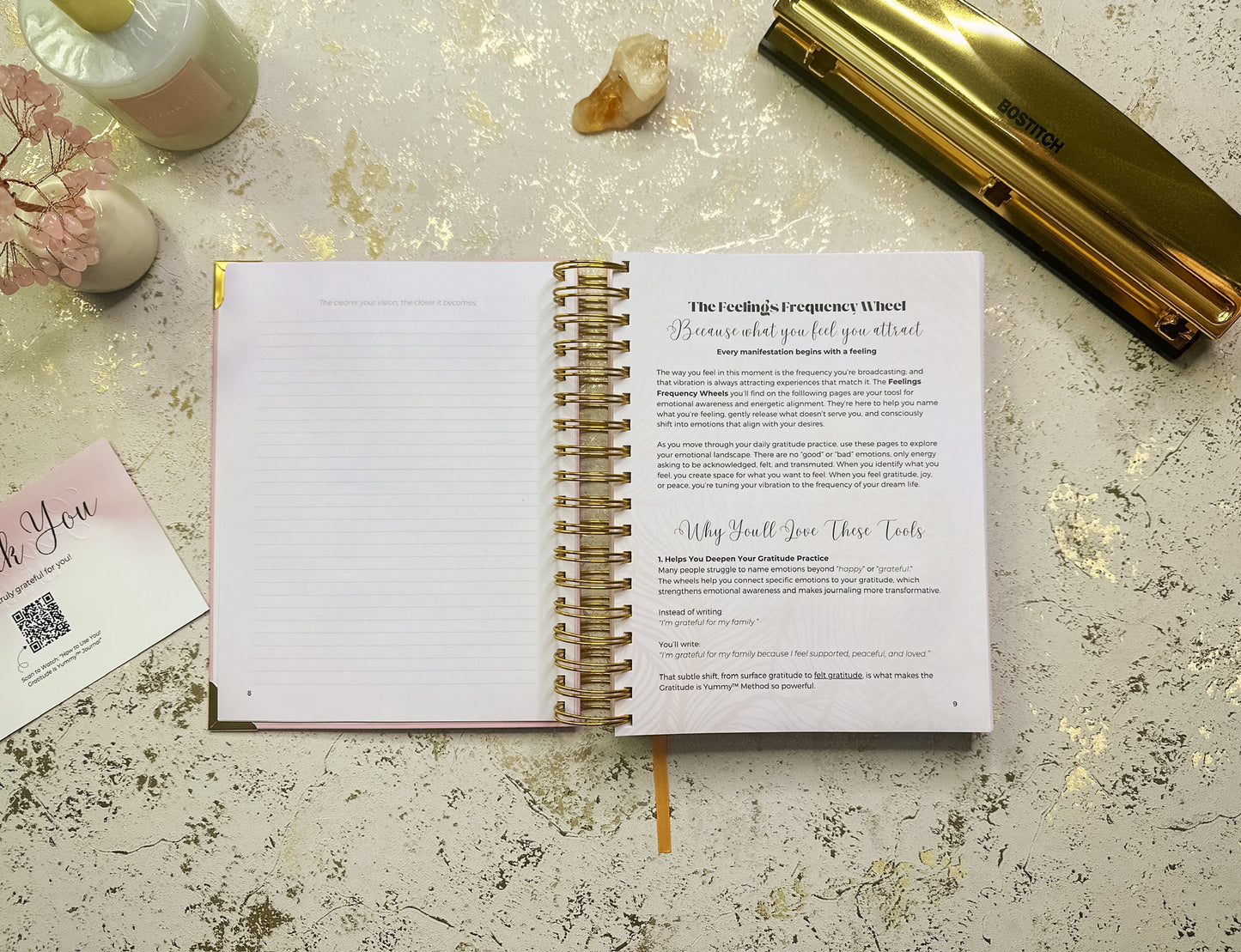 Open spiral-bound notebook with a printed page on a textured surface with decorative elements.

Open spiral-bound notebook on a textured surface with a pen and decorative items.