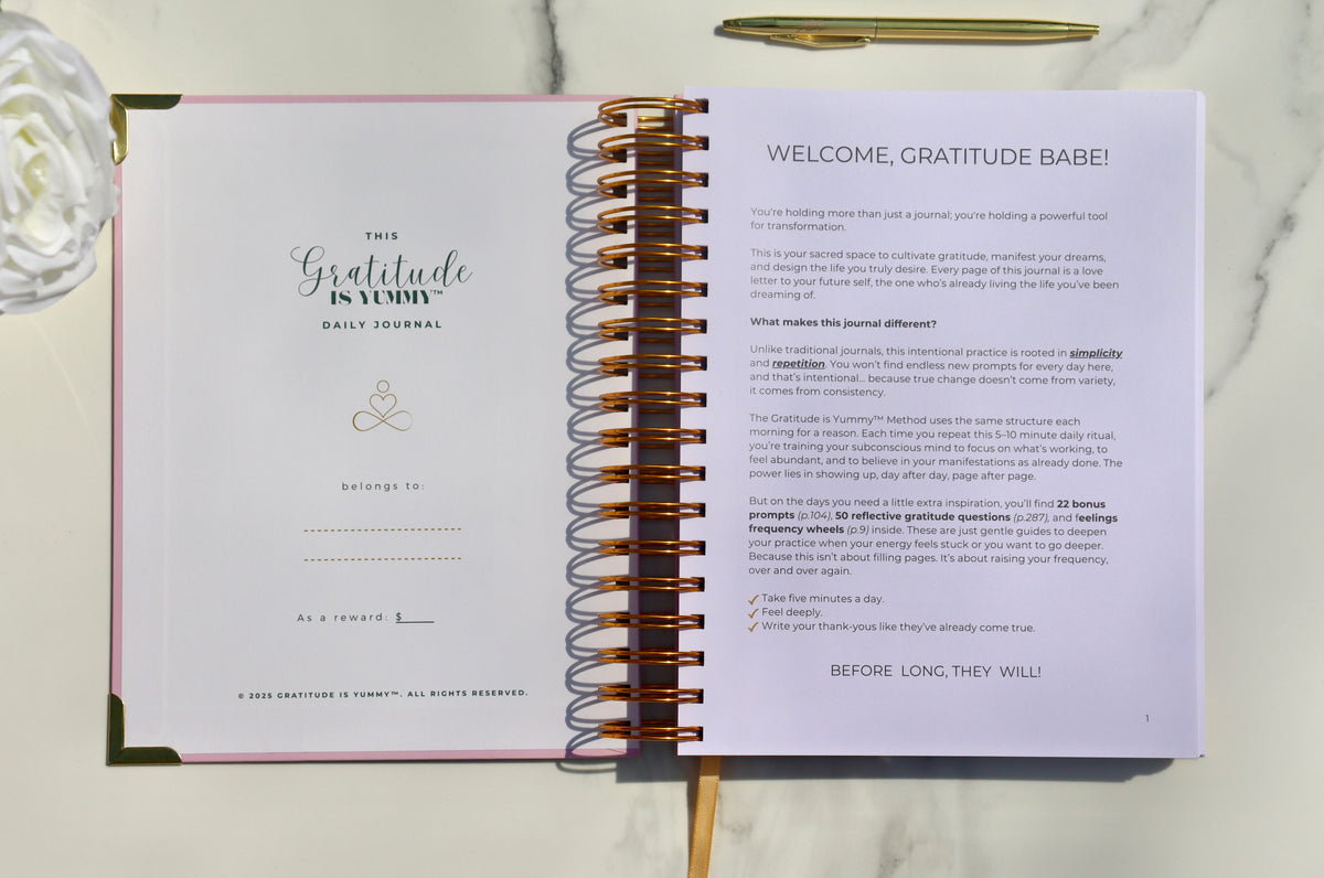 Open Gratitude is Yummy Journal with gratitude prompts, scripting space, gold pen, and pink flowers for manifestation journaling