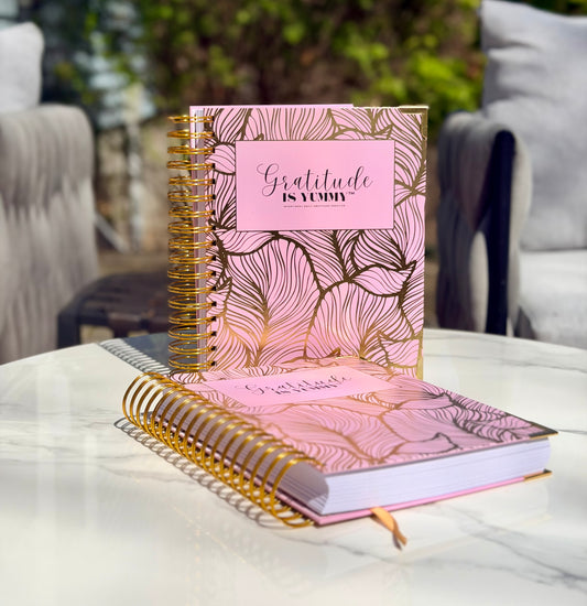 Gratitude is Yummy Journal with gold coil binding, pink floral cover, and gold pen for positive mindset tips and manifestation scripting